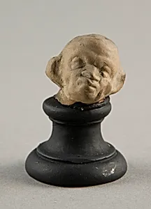 Head of a Grotesque Wearing Wreath by Ancient Greek