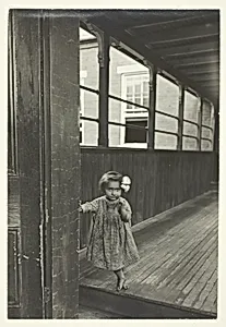 Little Girl Standing At Entrance To A Gallery