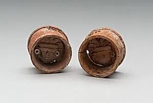 Pair of Ear Plugs with Face of Figure in Interior