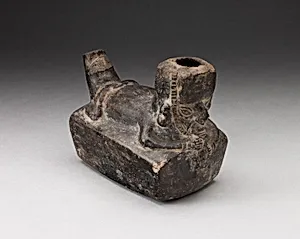 Vessel in the Form of a Flute-Player Laying atop Rectangle Shape
