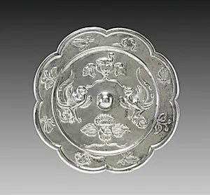 Lobed Mirror with Paired Phoenixes, a Nestling Bird, and a Lotus Blossom by Unknown Artist