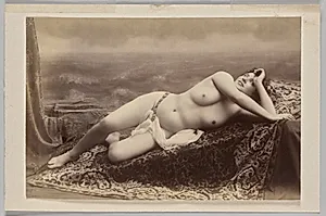 Untitled (reclining nude on carpet against painted backdrop of waves) by Unknown Artist