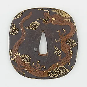 Sword Guard (<i>Tsuba</i>) Depicting Dragon and Paulownia Leaves With Tendrils (龍と桐唐草図鐔)