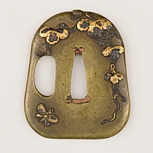 Sword guard (<i>Tsuba</i>) With the Motif of Paulownia Leaves, Tendrils, and Butterfly (蝶に桐唐草図鐔)