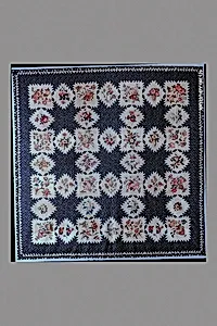 Feathered Star pattern quilt with chintz appliques