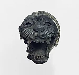 Furniture element carved in the round with the head of a roaring lion