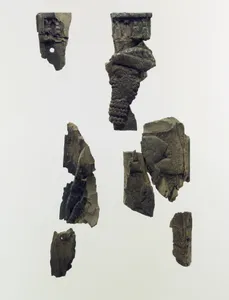Plaque fragments with a bearded male dignitary carrying a young goat