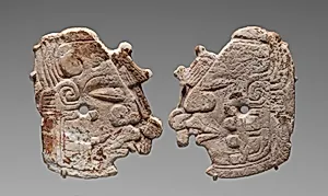 Pair of carved ornaments with the Maize God