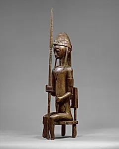 Seated Male Figure with Lance by Bamana numuw (blacksmith)