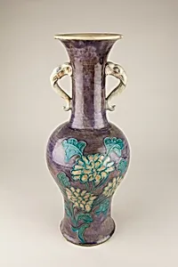 Vase with elephant head handles and floral decoration
