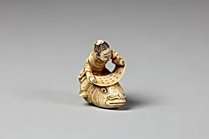 Netsuke of the Sage, Kinkō Carrying a Scroll and Seated on a Carp