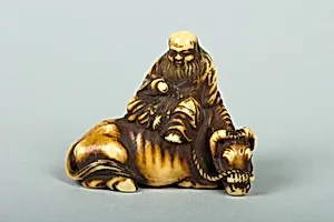 Netsuke of Man Sitting on a Recumbent Ox by Unknown Artist