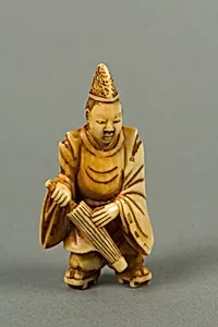 Netsuke of a Boy Carrying an Umbrella by Unknown Artist