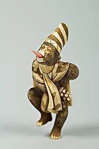 Netsuke of Monkey Wearing a Tall Cap and Carrying a Fan