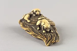 Netsuke of Puppies on a Bamboo Whisk