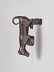 Door knocker in the shape of a small dog or puppy