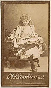 Actress gazing down at lap, from the Actresses series (N664) promoting Old Fashion Fine Cut Tobacco
