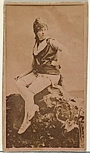 [Actress in studio posing on prop boulder], from the Actors and Actresses series (N145-8) issued by Duke Sons & Co. to promote Duke Cigarettes by W. Duke, Sons & Co.|American Tobacco Company