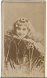 [Actress posing in grass with daisy in hair], from the Actors and Actresses series (N145-8) issued by Duke Sons & Co. to promote Duke Cigarettes by W. Duke, Sons & Co.|American Tobacco Company