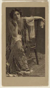 Portrait of a woman, seated, with her elbow resting on her knee, from the "Girls" series (T66), issued with Hunter Dog Cigarros by S. Monday & Sons