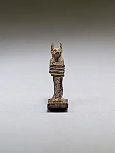 Anubis (?) supporting a large djed pillar