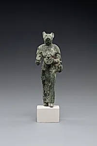 Bastet holding a lion-headed aegis, a sistrum (broken), and a basket