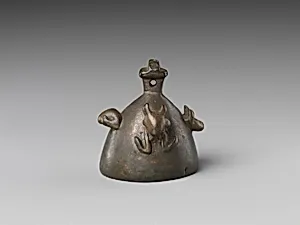 Bell with heads of a ram, a jackal, and a bovine wearing a yoke ending in uraei