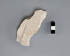Hieratic ostracon with remains of red numeral
