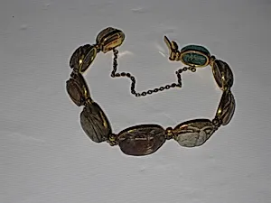 Nine scarabs set in modern bracelet.
