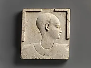 Plaque with head and shoulders of a priestly figure, opposite side head of priestly figure and most of a figure of crocodile-headed god