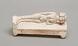Reclining female figure on a bed