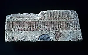 Relief with man carrying papyrus bundle