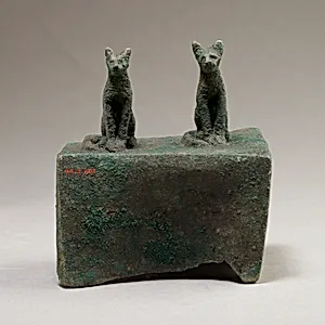 Two cats surmounting a box for an animal mummy