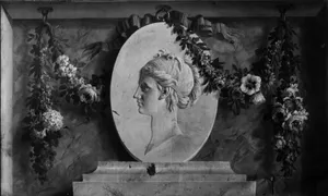Female bust in an oval medallion draped with a garland (one of a pair)