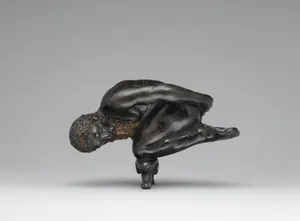 Oil lamp in the form of a bearded athlete balanced on his knees