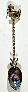 Souvenir spoon with row boat in grotto with high ceiling of rocks at Capri