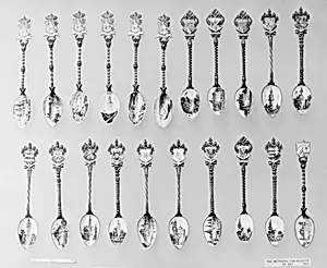Souvenir spoon with view of paddle boat on a river and arms of Spain