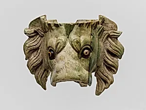 Bone lion's head protome with glass eyes