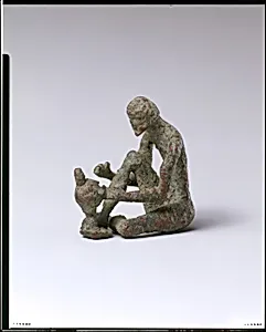 Bronze armorer working on a helmet