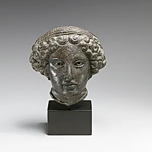 Bronze relief of the head of a woman