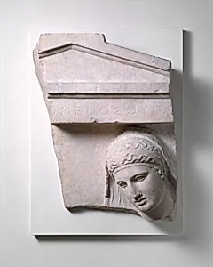 Fragment of a marble grave stele of a woman
