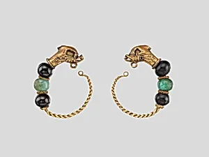 Gold, beryl, and garnet earring with head of a dolphin