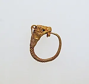 Gold earring with head of a goat