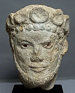 Limestone head of a bearded man