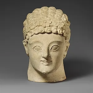 Limestone head of a beardless male
