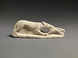 Limestone statuette of a coursing hound seizing a hare