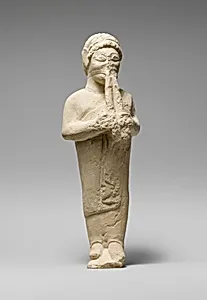 Limestone statuette of a flute-player