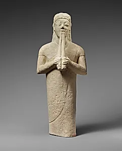 Limestone statuette of a male aulos player