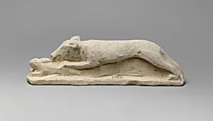 Limestone votive statuette of a hound seizing a hare