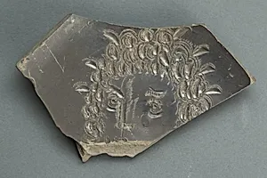 Plate with face, fragmentary